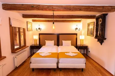a bedroom with two beds and two lamps at Secret Garden Residence in Paszkówka