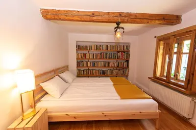 a bedroom with a bed and a book shelf at Secret Garden Residence in Paszkówka