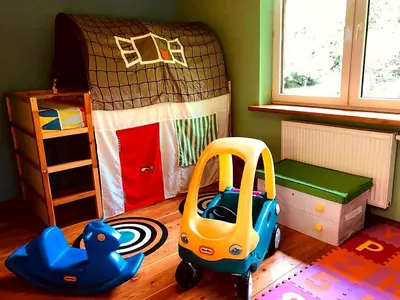 a childs bedroom with a toy car and a bed at Secret Garden Residence in Paszkówka