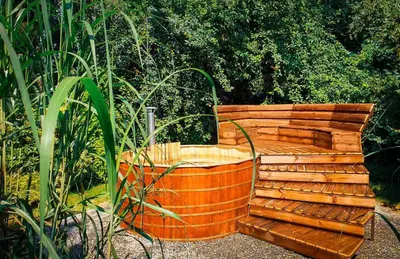 a wooden bench sitting in the middle of a garden at Secret Garden Residence in Paszkówka