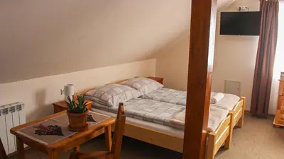 a room with a bedroom with a bed and a window at Gorczański Kącik in Ochotnica Dolna