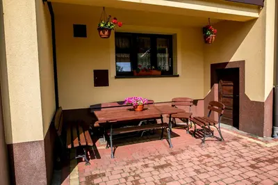 a living room with a couch and a table at Gorczański Kącik in Ochotnica Dolna