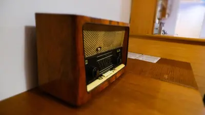 an old tv sitting on top of a wooden floor at Bailey Apartment in Kraków