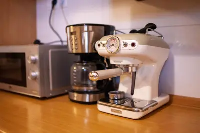 a mixer sitting on a counter next to a microwave at Bailey Apartment in Kraków