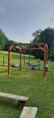 a park with a swing set in the grass at Dom na polanie in Brzeźnica