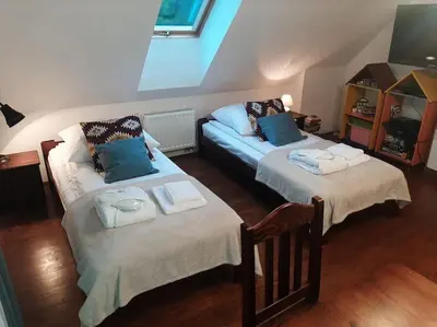 a living room with two beds and a couch at Dom na polanie in Brzeźnica