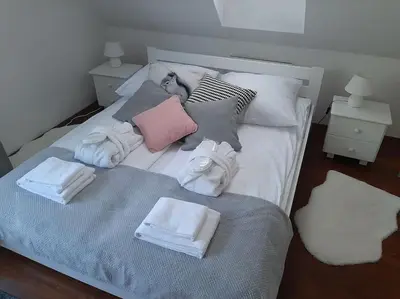 a bed with towels and pillows on it at Dom na polanie in Brzeźnica