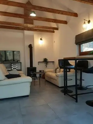 a living room with a couch and a table at Dom na polanie in Brzeźnica