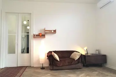 a living room with a brown couch and a door at Apartament Barbara - przy rynku in Wadowice