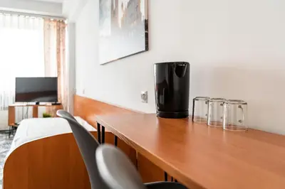 a room with a wooden table with chairs at Hotel Biała Gwiazda in Kraków