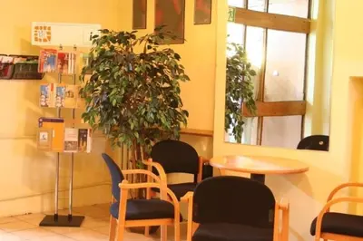 a room with chairs and a table and a plant at Hotel Biała Gwiazda in Kraków