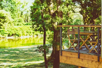 a screened in porch with a table and chairs at Apartamenty wśród drzew River Park Zator SPA JACUZZI in Zator