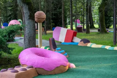 a group of colorful play equipment in a park at Apartamenty wśród drzew River Park Zator SPA JACUZZI in Zator