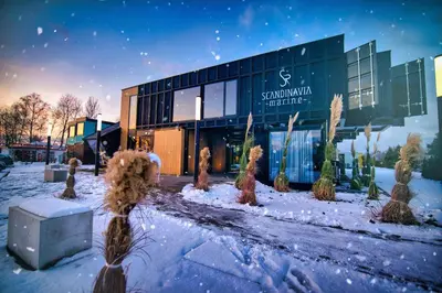 a building in the snow with trees in front of it at Scandinavia Zator, an Ascend Collection Resort in Zator