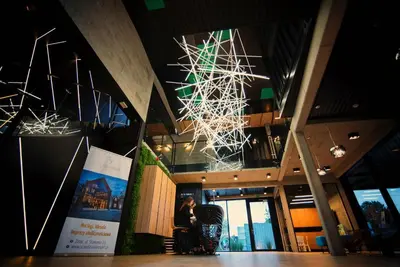 a woman standing in front of a building with a chandelier at Scandinavia Zator, an Ascend Collection Resort in Zator