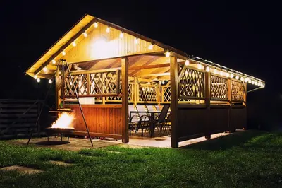 a gazebo with a grill in the yard at night at Barwald Hills - jacuzzi i piękny widok na Babią Górę i Beskidy in Wadowice