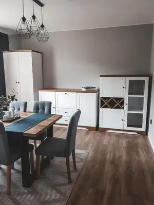a kitchen with a dining room table and chairs at Jaszczurowa Apartament in Jaszczurowa