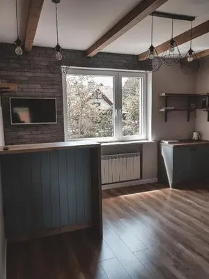 a kitchen with a bar in a room at Jaszczurowa Apartament in Jaszczurowa