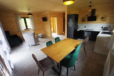 a room with a wooden floor and a room with a hallway at Michałówka Zawoja in Zawoja