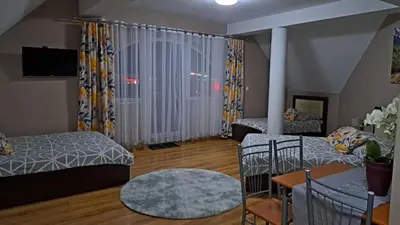 a living room with a bed and a table at Noclegi Damianek in Nowy Targ