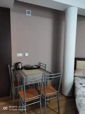 a table and chairs in a room with a bed at Noclegi Damianek in Nowy Targ