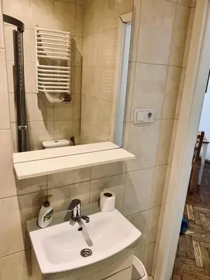 a bathroom with a sink and a mirror at Studio in Center in Kraków