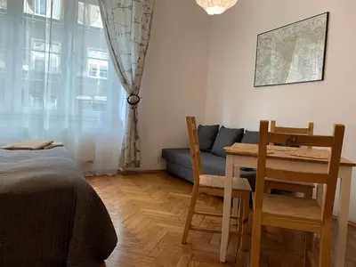a kitchen with red cabinets and a sink at Studio in Center in Kraków