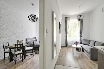 a bed in a room with a chair and a window at Apartament w centrum :) in Kraków