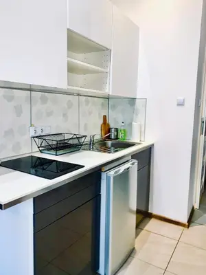 a bedroom with a bed and a table with chairs at Apartament w centrum :) in Kraków