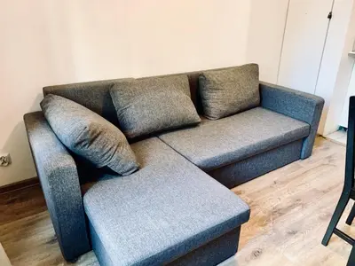 a living room with a couch and a window at Apartament w centrum :) in Kraków