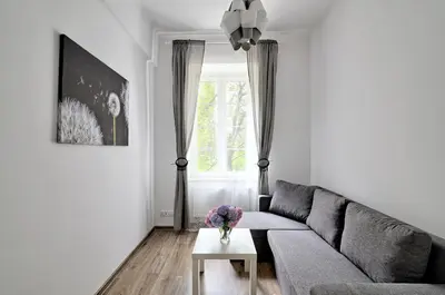 a bedroom with a bed and a table with chairs at Apartament w centrum :) in Kraków
