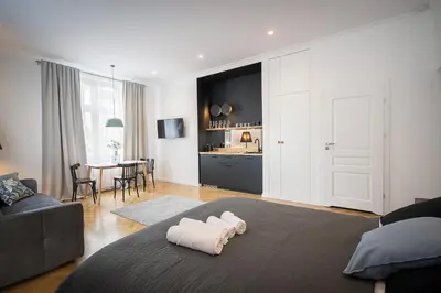 a living room with a bed with towels on the floor at Wanderlust Apartments in Kraków