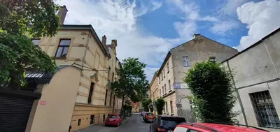 a city street with buildings and cars parked on the street at Wanderlust Apartments in Kraków