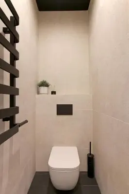 a bathroom with a white toilet in a room at Wanderlust Apartments in Kraków