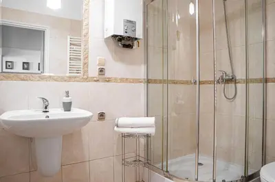 a bathroom with a sink and a shower at Main Square 18 view 1 in Kraków