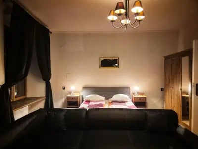 a living room with a bed and a couch at Main Square 18 view 1 in Kraków