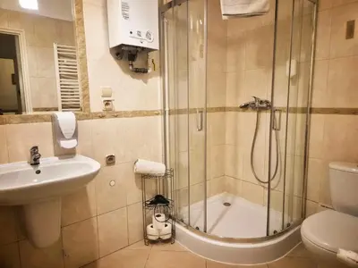a bathroom with a shower and a sink and a toilet at Main Square 18 view 1 in Kraków