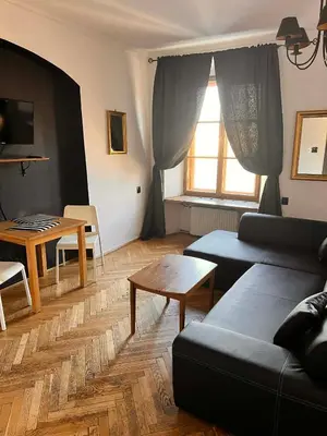 a living room with a couch and a table at Main Square 18 view 1 in Kraków