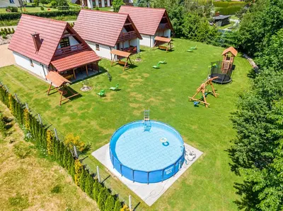 an aerial view of a backyard with a swimming pool at Domki Pod Czarnym Groniem in Rzyki