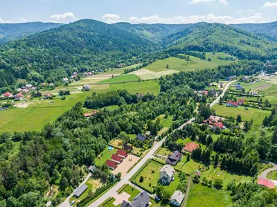 an aerial view of a village in the mountains at Domki Pod Czarnym Groniem in Rzyki