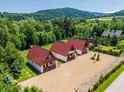 an aerial view of a house with red roofs at Domki Pod Czarnym Groniem in Rzyki