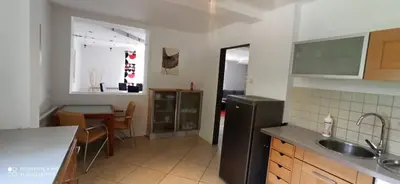 a kitchen with a table and chairs and a staircase at DOM W GÓRACH in Maków Podhalański