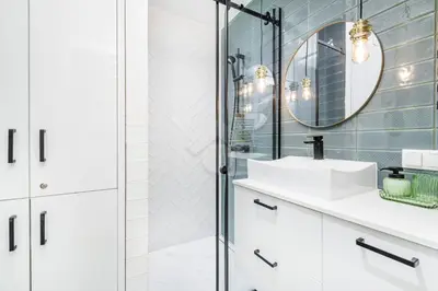 a bathroom with a shower and a sink and a mirror at Kraków City Center Luxury Apartment in Kraków