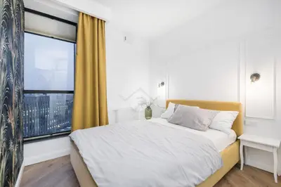 a bedroom with a bed and a large window at Kraków City Center Luxury Apartment in Kraków