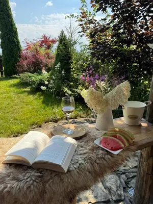 a table with an open book and a glass of wine at Widokowa Chata in Obidowa