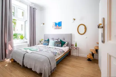 a bedroom with a bed and a window at Apartament Ex Libris in Kraków
