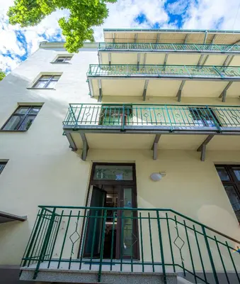 a building with balconies on the side of it at Apartament Ex Libris in Kraków