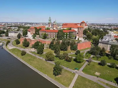 an aerial view of a building next to a body of water at WawelSee Apartments in Kraków