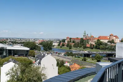 a view of a city with a river and buildings at WawelSee Apartments in Kraków