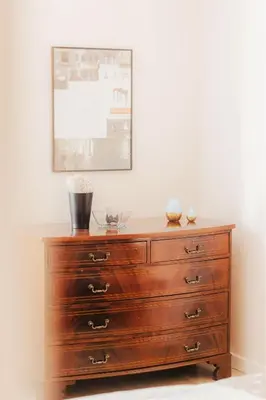 a wooden dresser in a room with a picture on the wall at DeLux Apartament OldTown Kochanowskiego 30 Kraków in Kraków